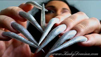 lengthy acute fingernails in holographic silver.
